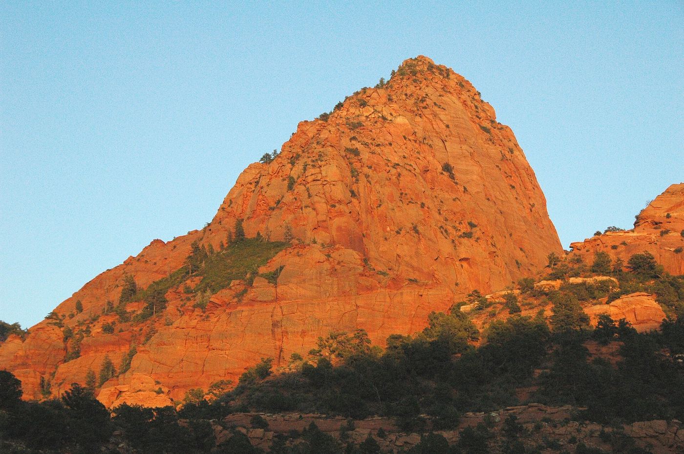 A red sandstone peak lit by the setting sun